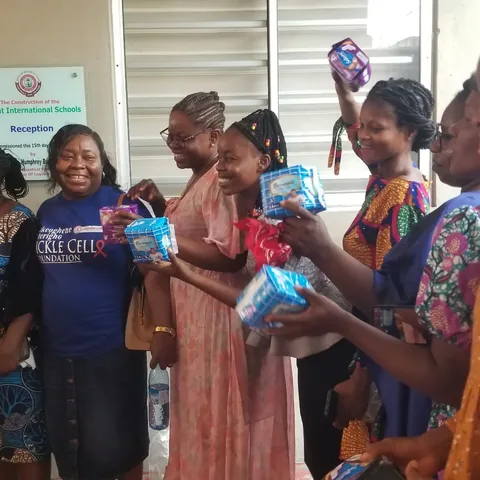 Girls with their free pads at Delight International Schools