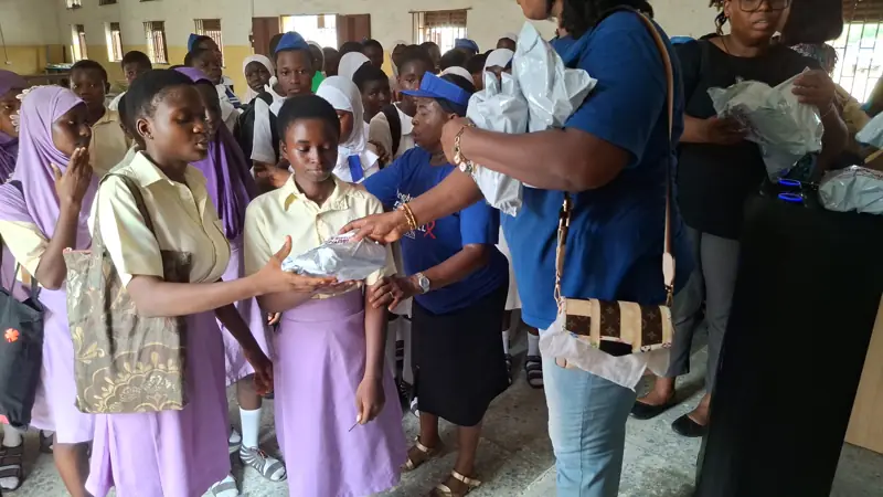 Volunteers handing out hygiene kits to students