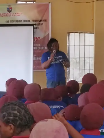 A volunteer speaking to the students
