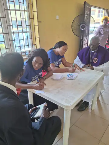 Volunteers and clergy at a consultation table