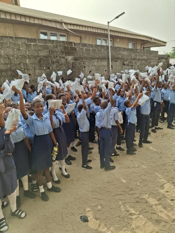 Students of PATS raising their hygiene kits