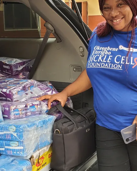 A volunteer unloading packs of sanitary pads